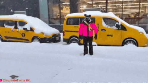 Person in Pink Jacket in Front of Yellow NYC Taxi