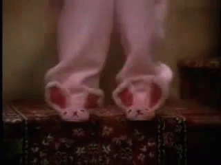 Person in Pink Pajamas and Bunny Slippers on a Box