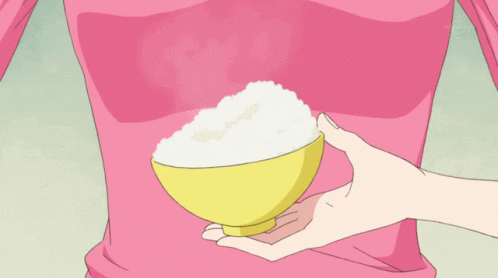 Person in Pink Shirt Holding Yellow Rice Bowl