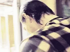 Person in Plaid Shirt Looking Down