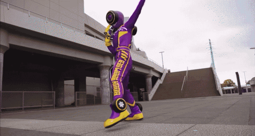 Person In Purple And Yellow Feel Good Rider Costume GIF