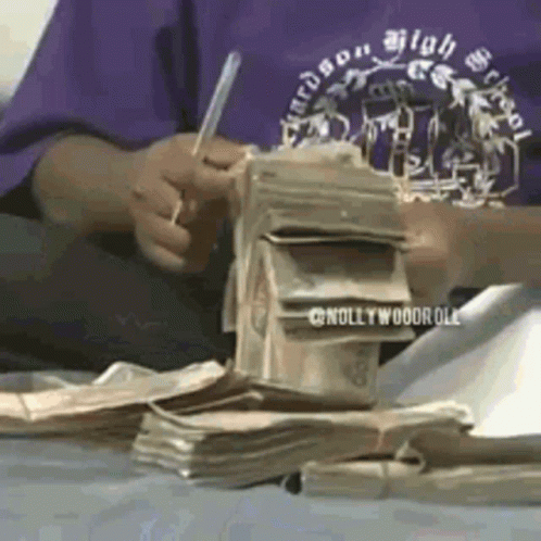 Person In Purple Shirt Writing On Money GIF