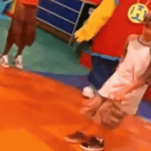 Person In Red And Yellow Costume Beside Child In White GIF