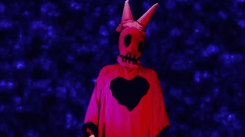 Person in Red Costume with Skull and Heart