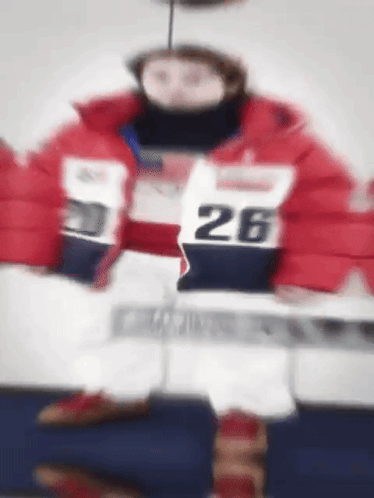 Person in Red Jacket Number 26