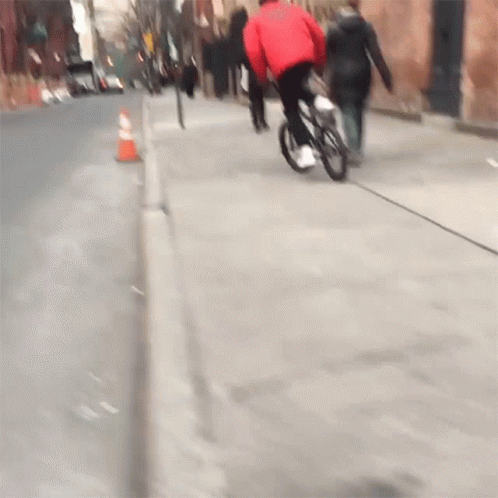 Person in Red Jacket Riding Bike