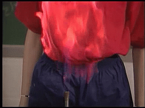 Person in Red Shirt and Blue Shorts