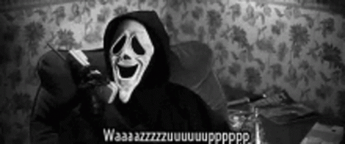 Person In Scary Mask Sitting In Chair GIF