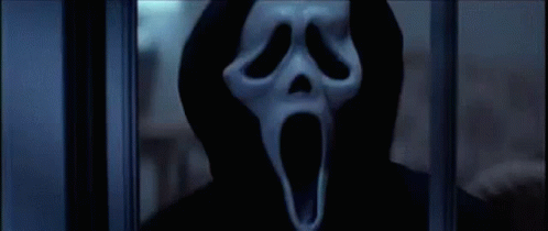 Person in Scream Mask Behind Window