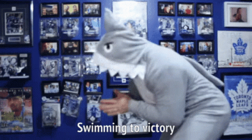 Person in Shark Costume Swimming to Victory