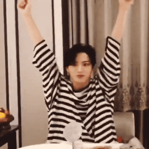 Person in Striped Shirt With Arms Up