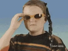 Person in Sunglasses and Adult Swim Sweater