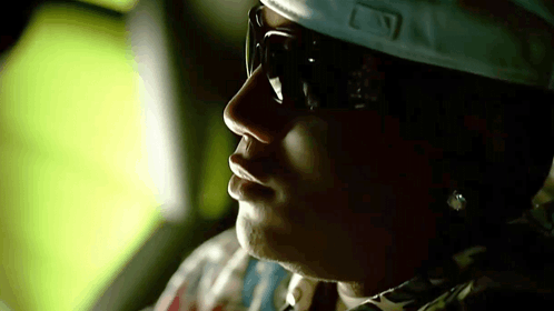 Person in Sunglasses and Baseball Cap With Letter L