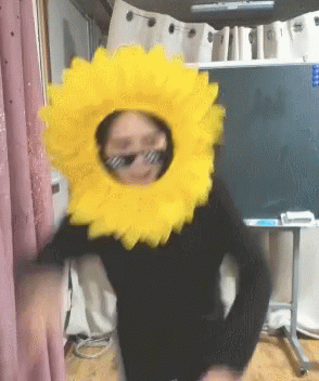 Person in Sunglasses and Sunflower Headpiece