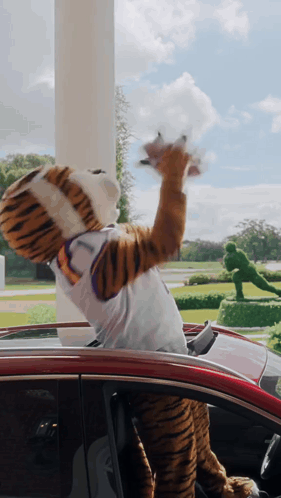 Person in Tiger Mascot Costume Sitting in Car