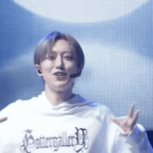 Person in White Hoodie With Jesus Text