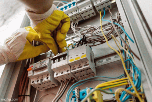 Person in Yellow Gloves Working on Electrical Box