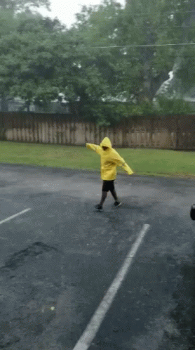 Person In Yellow Raincoat Dancing GIF