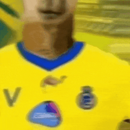 Person in Yellow Shirt With Letter V