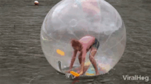 Person Inside Clear Ball Floating in Water