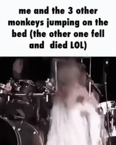 Person Jumping on Bed With Drum Set