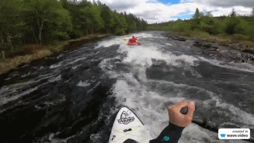 Person Kayaking on River