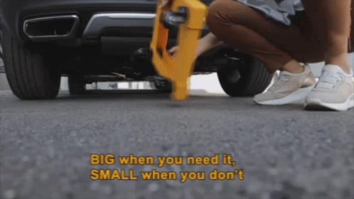 Person Kneeling Under Car Saying Big When You Need It Small When You Don't