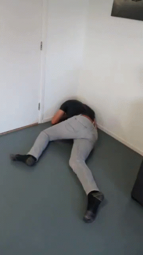 Person Laying Floor Head in Corner
