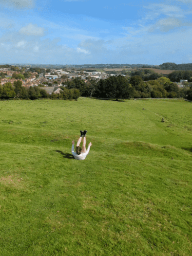Person Laying On Back In Grass GIF