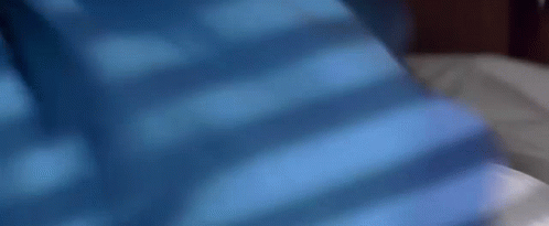 Person Laying On Bed With Blue Background GIF