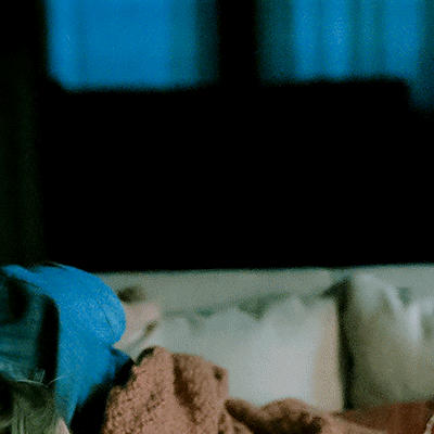Person Laying on Couch With Blanket