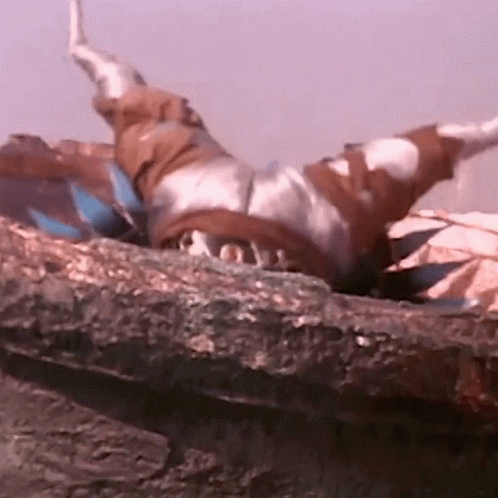 Person Laying on Rock With Arms Outstretched
