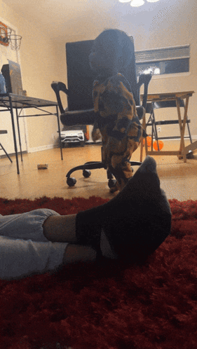 Person Laying With Feet Up and Dog Behind