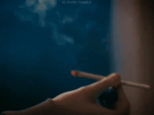 Person Lighting Cigarette With Lighter GIF