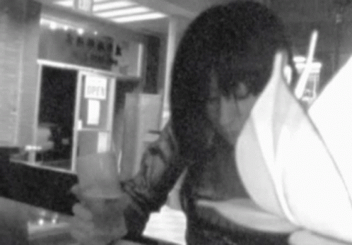 Person Looking at Menu in Front of Open Sign
