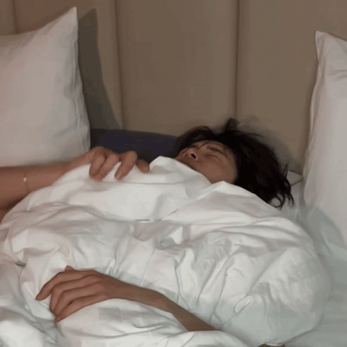 Person Lying In Bed With White Blanket GIF