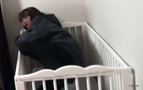 Person Lying in White Crib With SPM