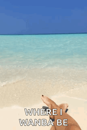 Person Lying on Beach Feet in Water