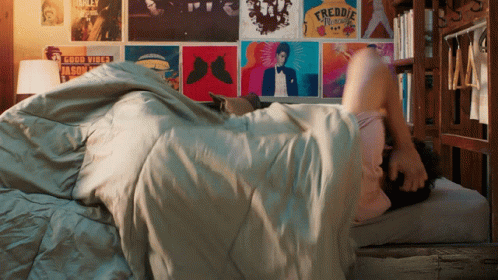 Person Lying On Bed With Freddie Mercury Poster GIF