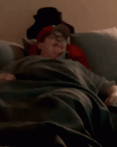 Person Lying on Bed with Hat