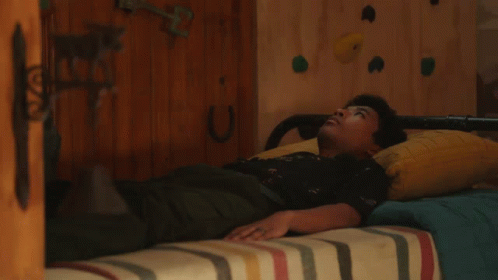 Person Lying on Bed with Horseshoe