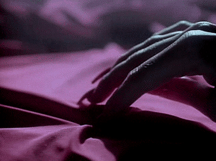Person Lying on Bed with Pink Sheet