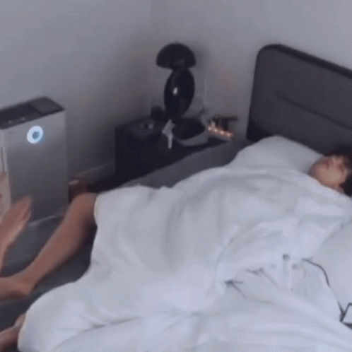 Person Lying on Bed With White Sheets