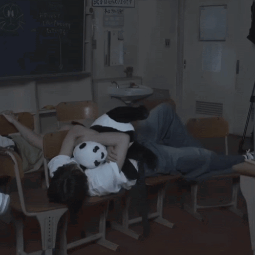 Person Lying On Chair With Panda Stuffed Animal GIF