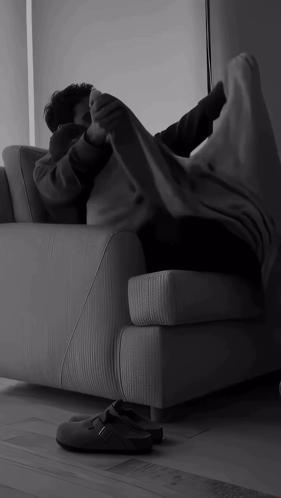 Person Lying on Couch with Feet Up