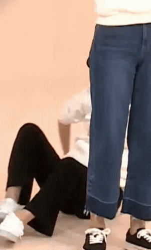 Person Lying on Floor Legs Crossed Another Standing