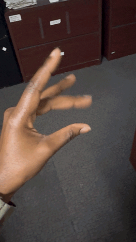 Person Making Triangle Hand Gesture