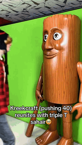 Person Next to Tree Trunk Statue