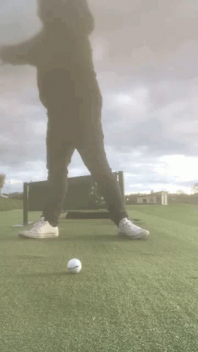 Person on Golf Course With Golf Ball