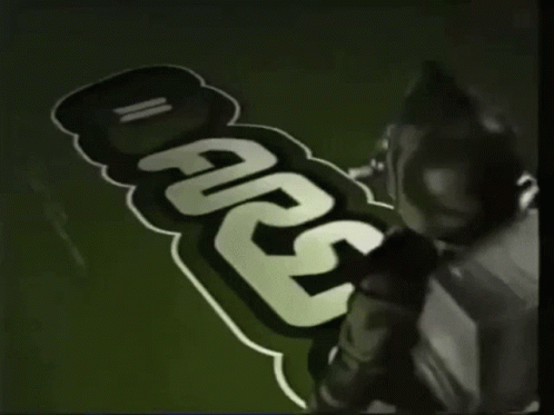 Person Painting Carlsberg on Green Background